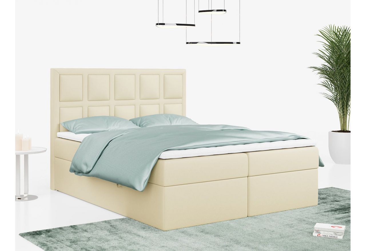 Kremowe łóżko kontynentalne z tapicerką z ecoskóry PREMIUM 5 wyposażone w wysokie, ozdobne wezgłowie, 120x200