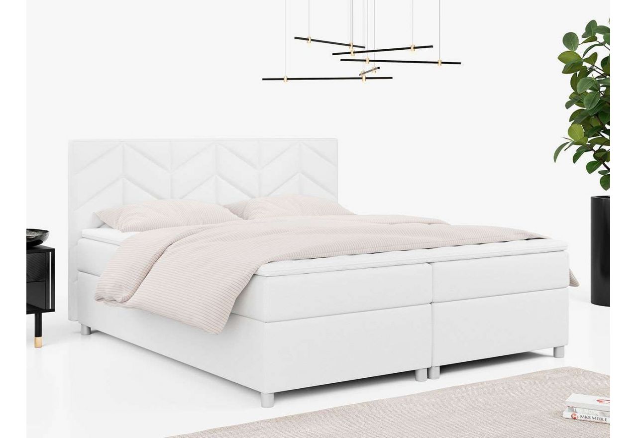Obszerne białe łóżko kontynentalne z tapicerką z ecoskóry i ozdobnym wezgłowiem PINO 180x200