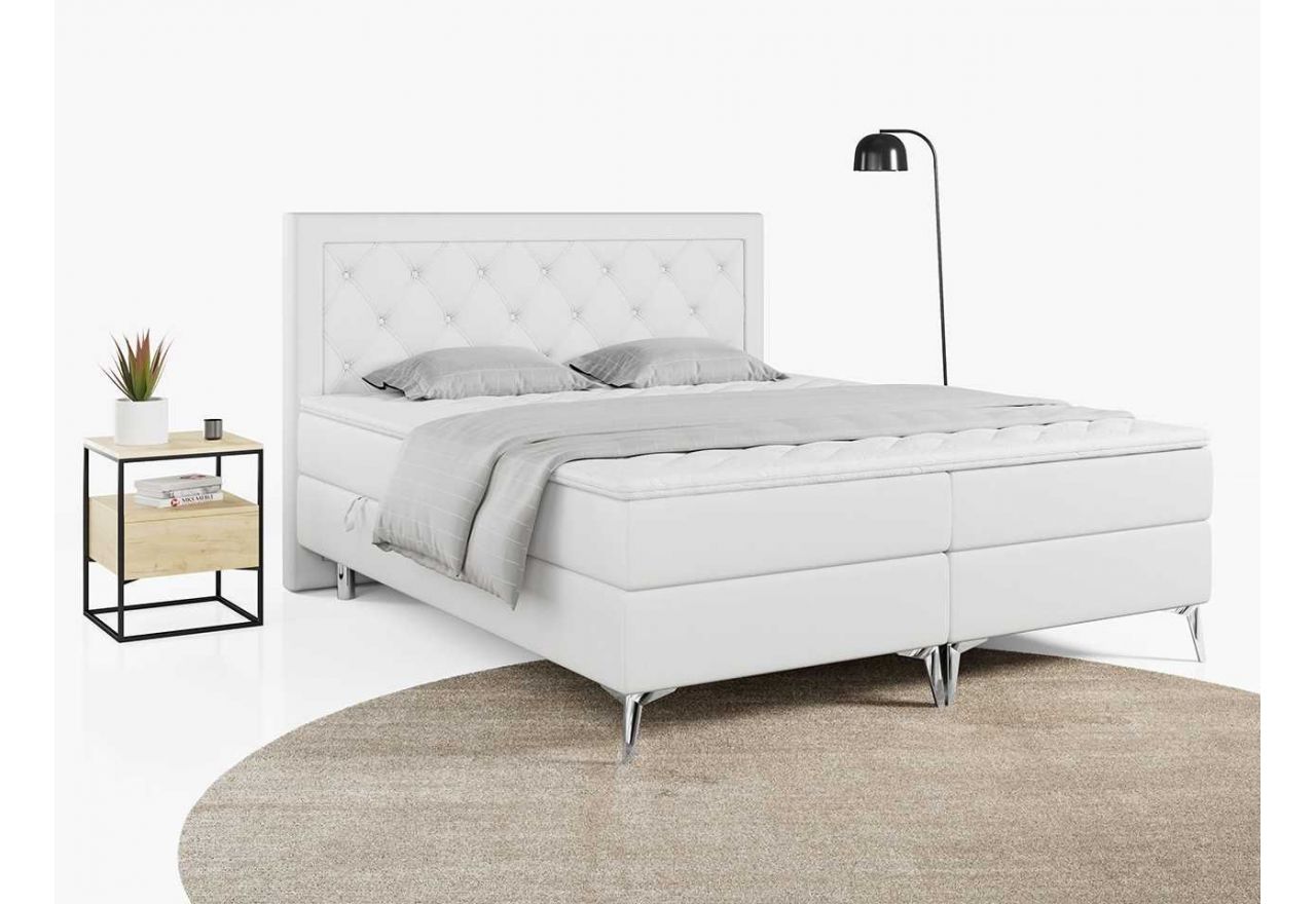 Białe łóżko kontynentalne z tapicerką z ecoskóry, DUNAJ ze sprężynowym materacem i pikowanym wezgłowiem 140x200